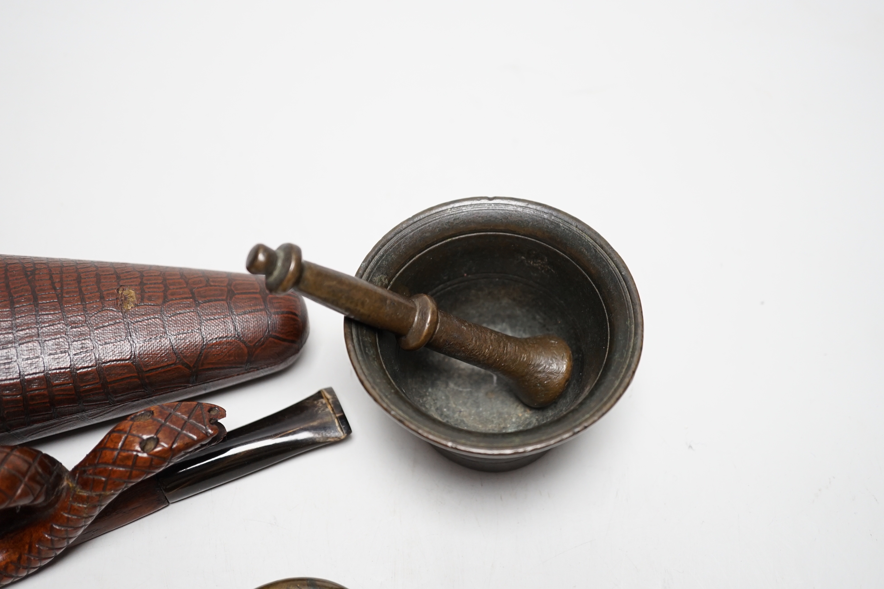 A novelty cased pipe, a miniature pestle and mortar and a novelty vesta case